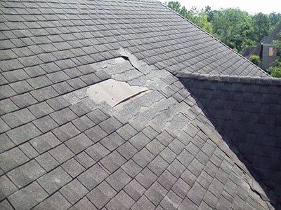Roof with broken shingles